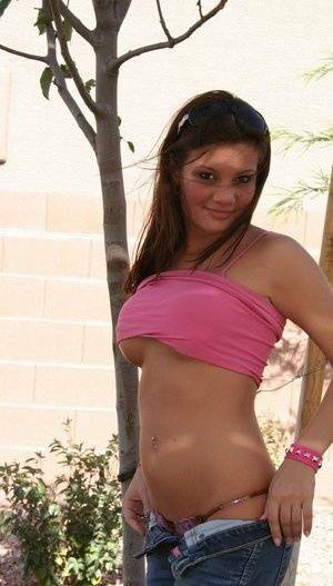 Amateur chick Kate Crush sets her perky tits free outdoors in denim jeans on fansgirls.net