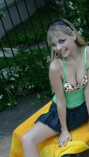 Young blonde Jana Jordan exposes her pretty bra and panties by a swimming pool - Jordan on fansgirls.net