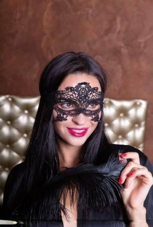 Sexy brunette Leyla Lee removes a mask and robes to pose nude with a feather on fansgirls.net