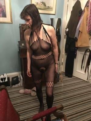 Older amateur Slut Scot Susan shows her beaver on a bed in a bodystocking on fansgirls.net