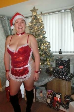 Busty blonde Barby masturbates her shaved pussy near the Christmas tree on fansgirls.net