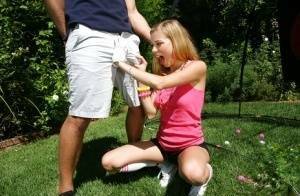 Young blonde girl Nicole Ray giving large dick oral sex outdoors on lawn on fansgirls.net
