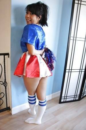 Tiny Asian cheerleader May Lee posing in cute uniform and socks on fansgirls.net