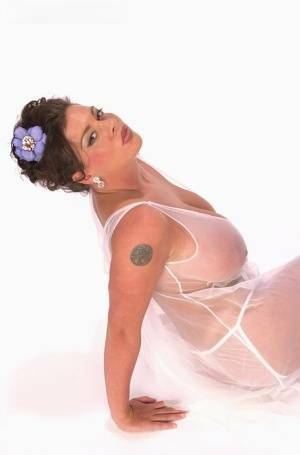 Buxom Linsey Dawn poses to flaunt her droopy tatas in sheer lingerie on fansgirls.net