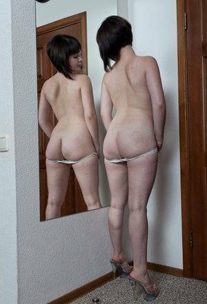 White teen with a full bush admires herself in mirror while disrobing on fansgirls.net