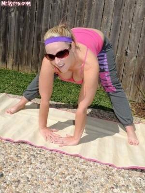 Blonde chick Dee Siren frees her huge ass from yoga pants outdoors on yoga mat on fansgirls.net