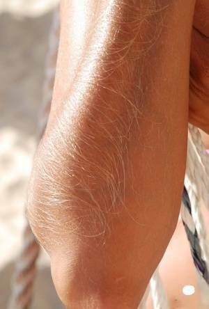 Amateur model Lori Anderson shows her hairy arms in a bikini and sunglasses on fansgirls.net