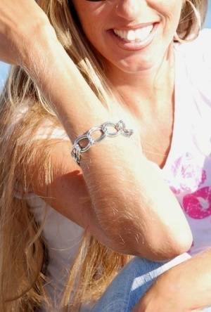 Amateur model Lori Anderson shows off her hairy arms while fully clothed on fansgirls.net