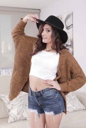 Latina babe Penelope Cum flaunting nice ass in denim shorts and cowgirl hat on fansgirls.net