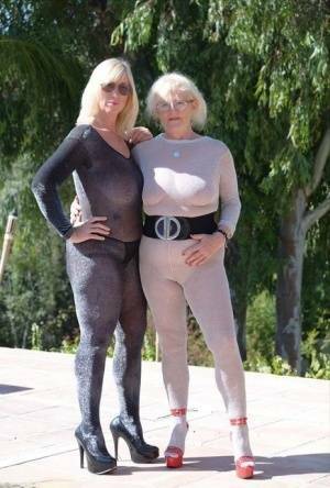 Mature blonde Melody and her lesbian lover bare their boobs on a building site on fansgirls.net