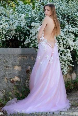 Beautiful girl Elle Tan slips off wedding dress to pose nude in garden on fansgirls.net