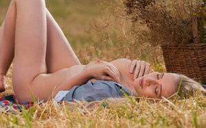 Blonde teen Penelope G displays her great body in a freshly cut farmer's field on fansgirls.net