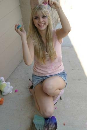 Sweet blonde teen Jana Jordan flashes upskirt panties while eating chocolate - Jordan on fansgirls.net