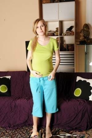 Smiley pregnant amateur with puffy nipples and hairy gash getting naked on fansgirls.net