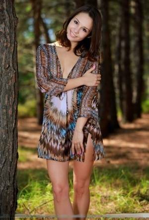 Sweet teen with an ass to die for disrobes for great nude poses in a forest on fansgirls.net