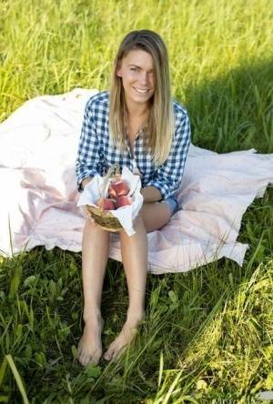 Nice teen Paulina gets completely naked on a blanket in a field on fansgirls.net