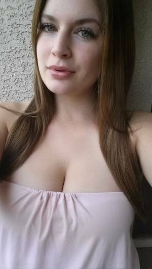 Plump amateur Danielle takes topless and clothed selfies around the house on fansgirls.net