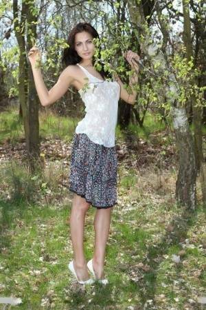 Long legged Michaela Isizzu flashes naked upskirt and poses nude in the forest on fansgirls.net