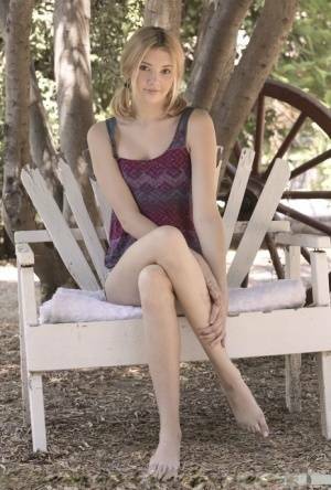 Teen first timer Lena Anderson vaunts her lithe body under a tree outside on fansgirls.net