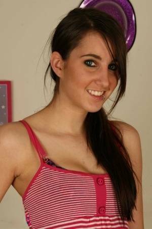 Young brunette Stacy H gets completely naked on a wooden table on fansgirls.net