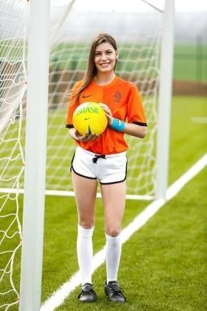 Lilly P is undressing her soccer uniform while on the field with a ball on fansgirls.net