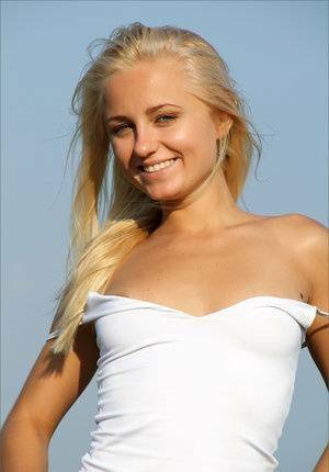 Blonde teen gets totally naked to for a solo shoot up on a hilltop on fansgirls.net