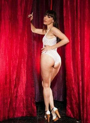 Leggy brunette Dana Dearmond sets her boobs free from bodysuit in heels on fansgirls.net