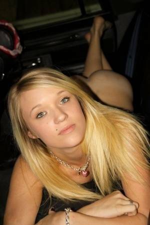 Blonde amateur Teagan slides lace panties aside to get naked inside a vehicle on fansgirls.net