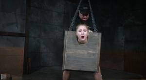 Blonde girl Odette Delacroix is made to suck a black cock with head in stocks on fansgirls.net