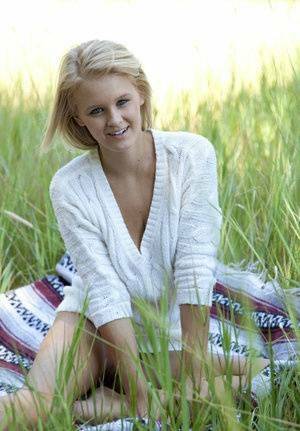Blue eyed blonde teen Marie casts off her clothes to pose nude in a field on fansgirls.net