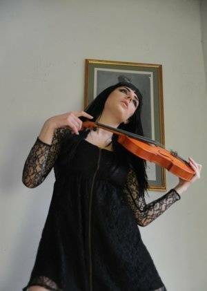 Dark haired violin player Sam Bentley strikes great poses while getting naked on fansgirls.net