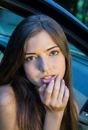 Beautiful teen girl models in the nude on passenger seat of car with door open on fansgirls.net