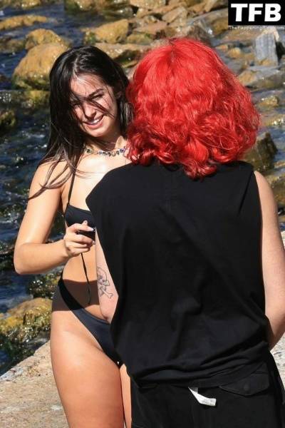 Addison Rae Displays Her Curves in a Black Bikini on Holiday with Omer Fedi on Lake Como on fansgirls.net