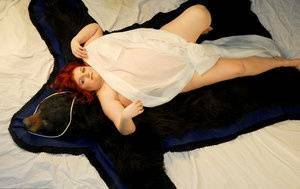 Fat redhead Black Widow AK models totally naked on a bearskin rug on fansgirls.net