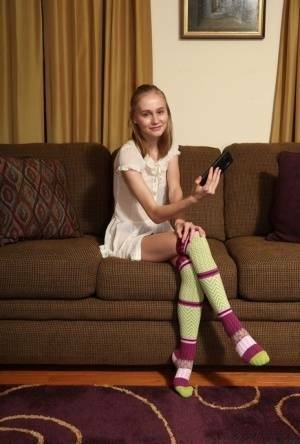 Adorable teen Alicia Williams takes a selfie before getting naked in OTK socks on fansgirls.net