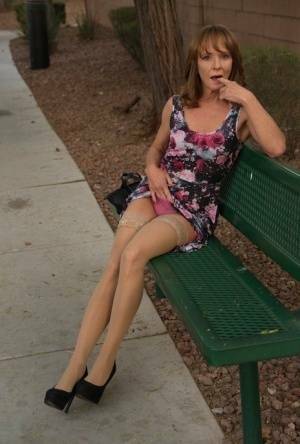 Aged lady flashes her tits and twat on a public bench before disrobing at home on fansgirls.net