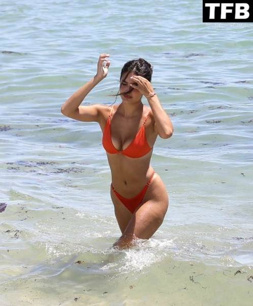 Tao Wickrath Stuns in Small Orange Bikini on the Beach in Miami on fansgirls.net